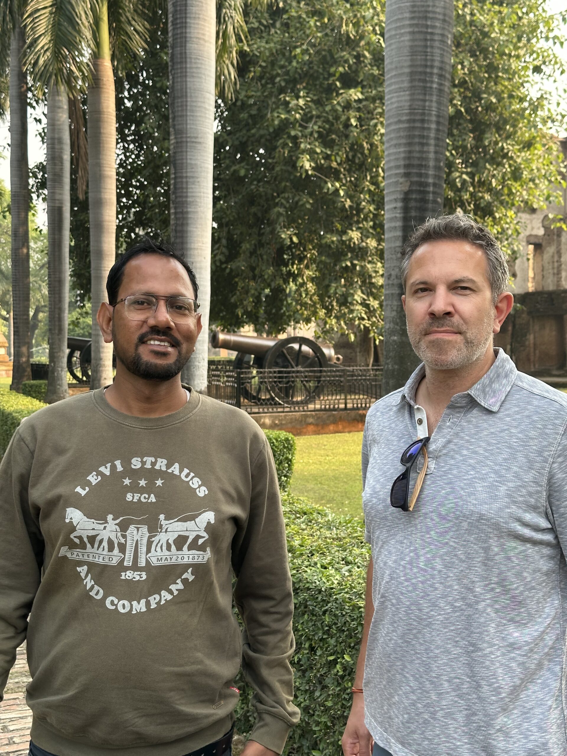 Two men standing together in a garden in Lucknow after first meeting through Hindi lessons online